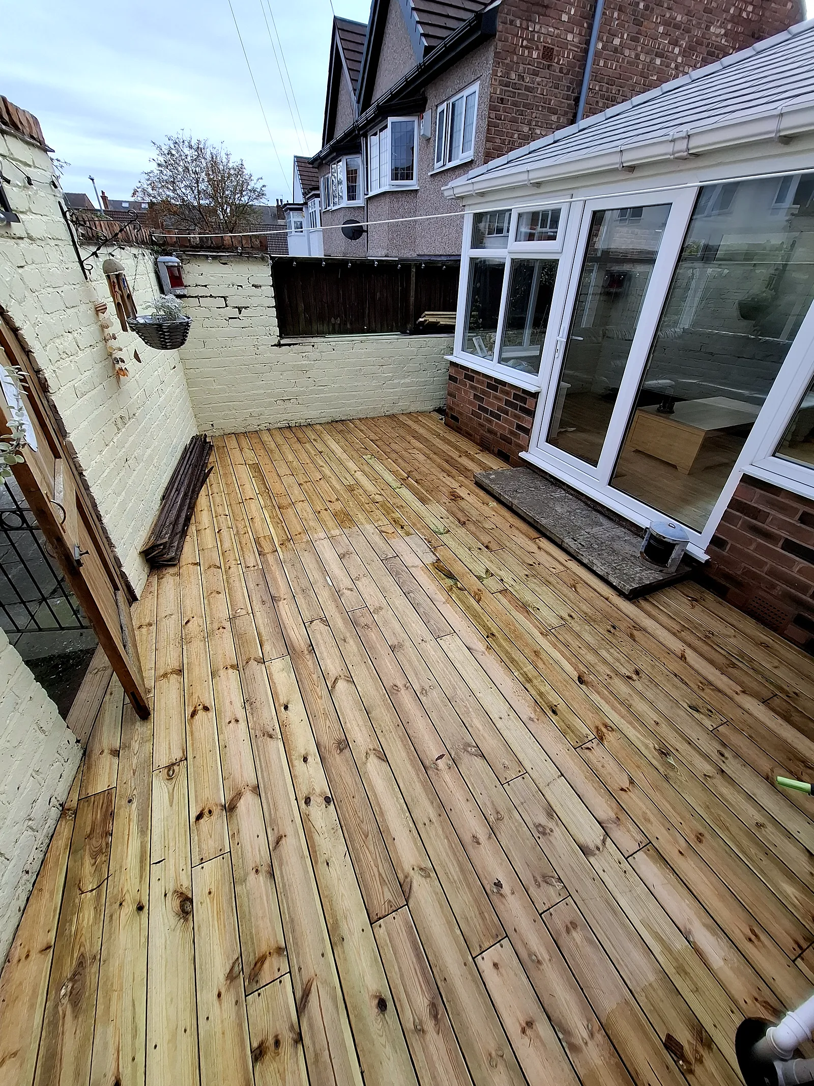 New timber decking laid across a rear yard
