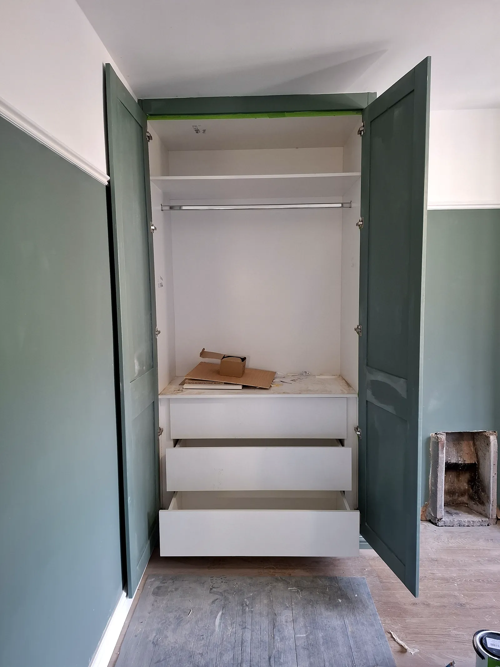 Inside a fitted wardrobe with a drawer pulled out