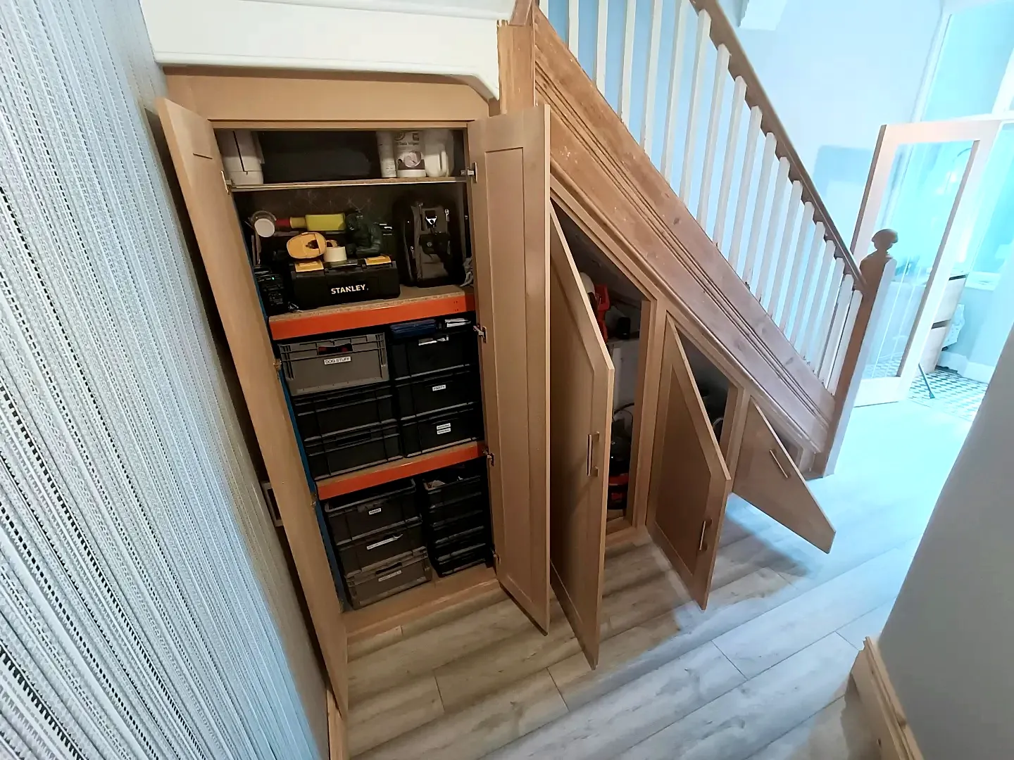 Under-stairs cupboards fitted out with shelves