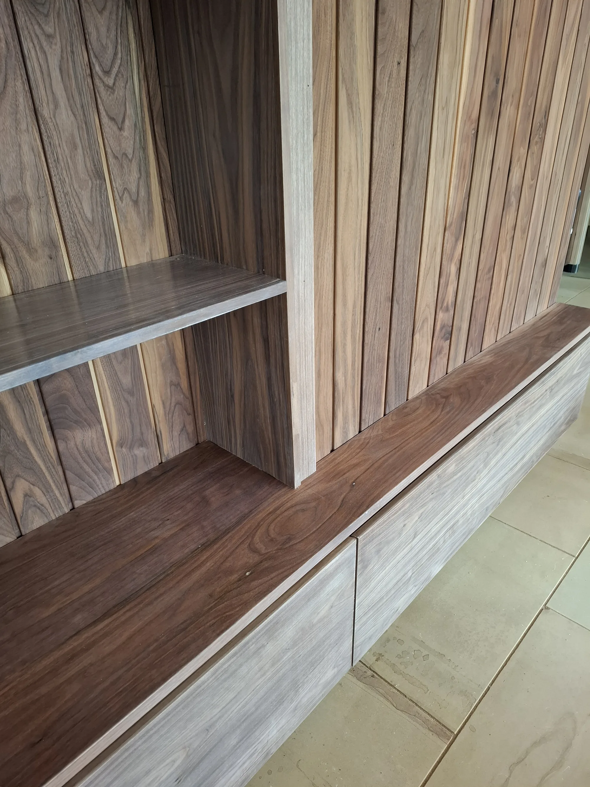 Close-up of the walnut shelving and drawer fronts