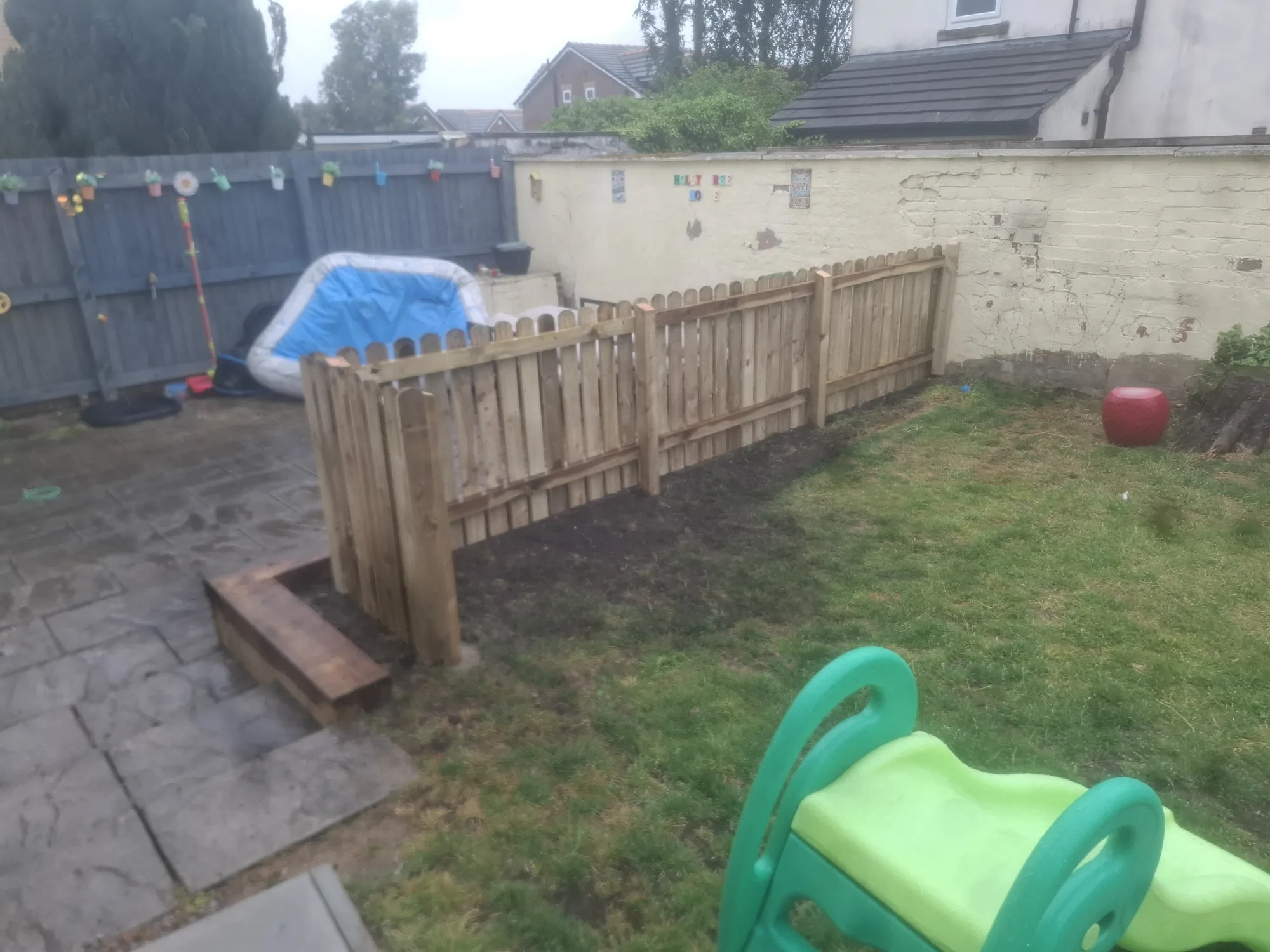 Picket fence running across the garden