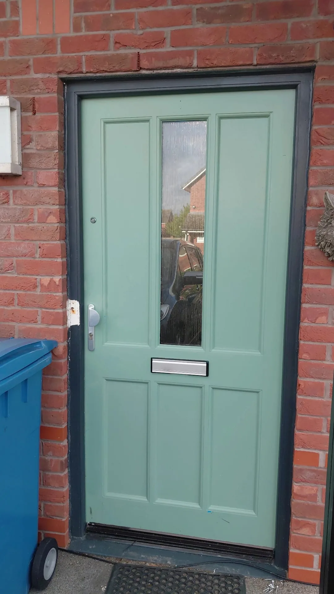 Sage green hardwood front door and frame
