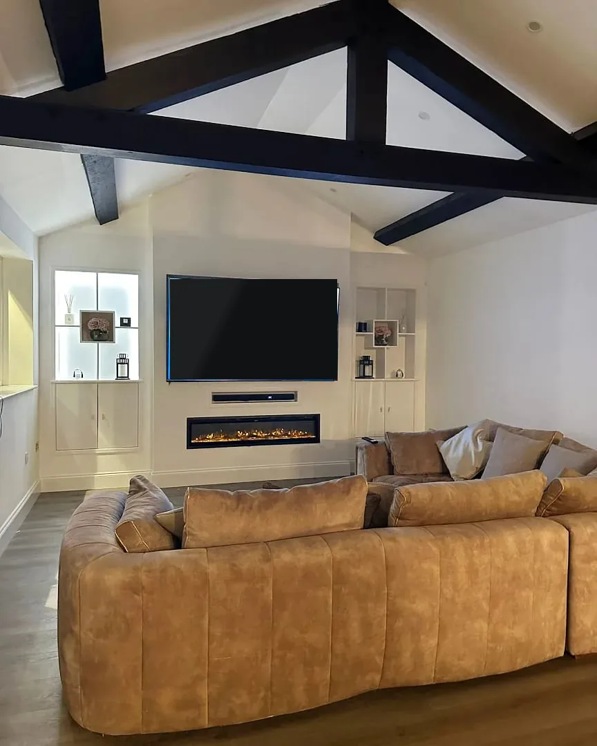 Media wall with an electric fire, TV and lit alcove shelving