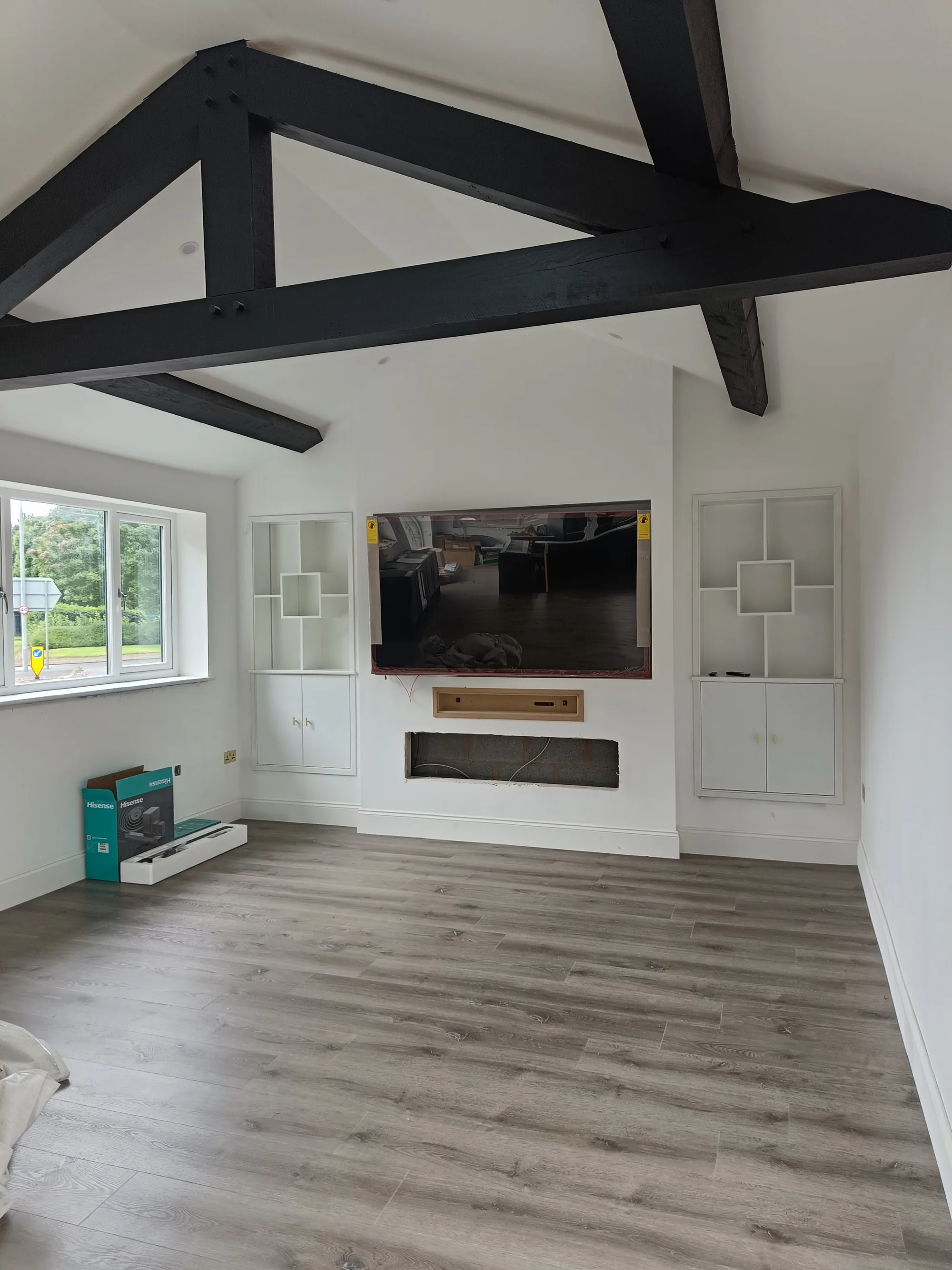 The finished media wall under the vaulted ceiling
