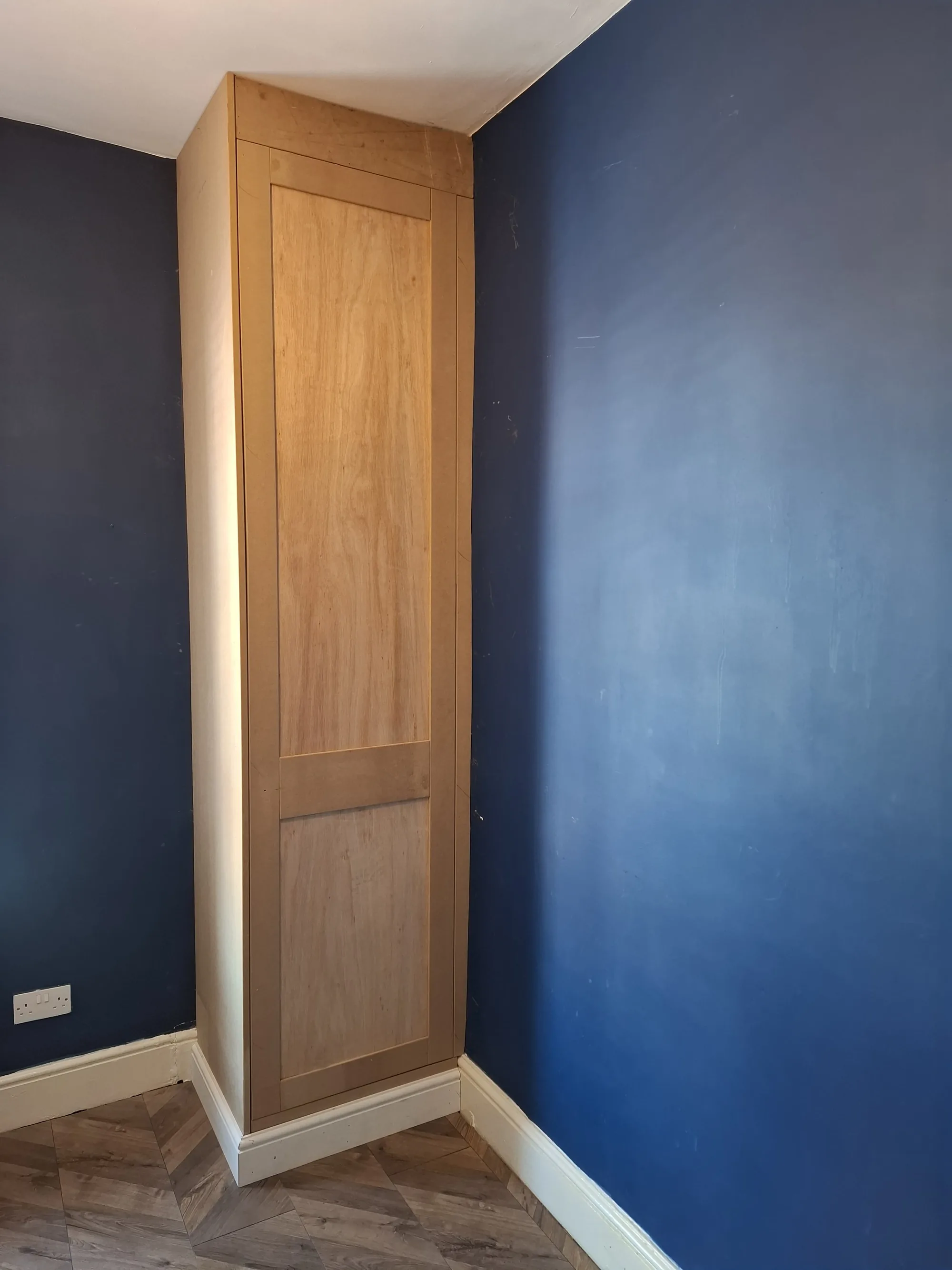 Floor-to-ceiling cupboard built around a boiler