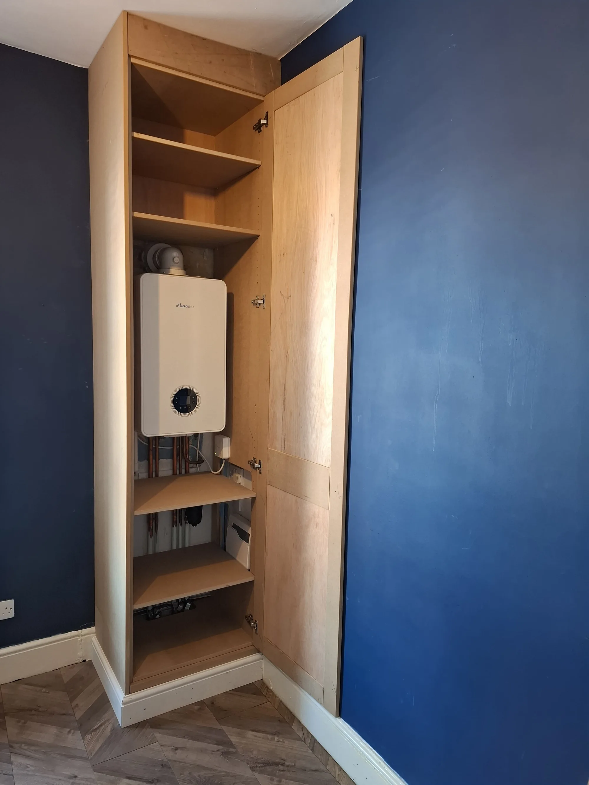 Boiler cupboard open, with shelving inside