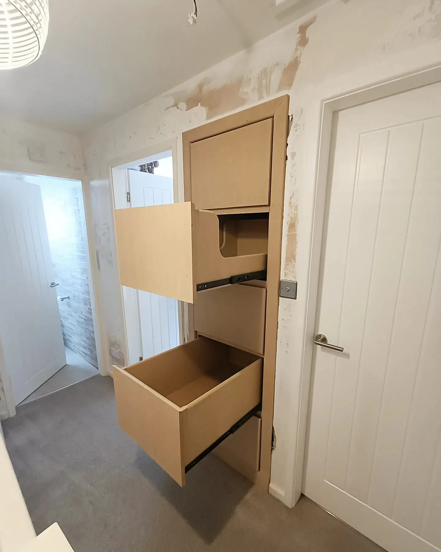 Pull-out drawers open in the hallway unit