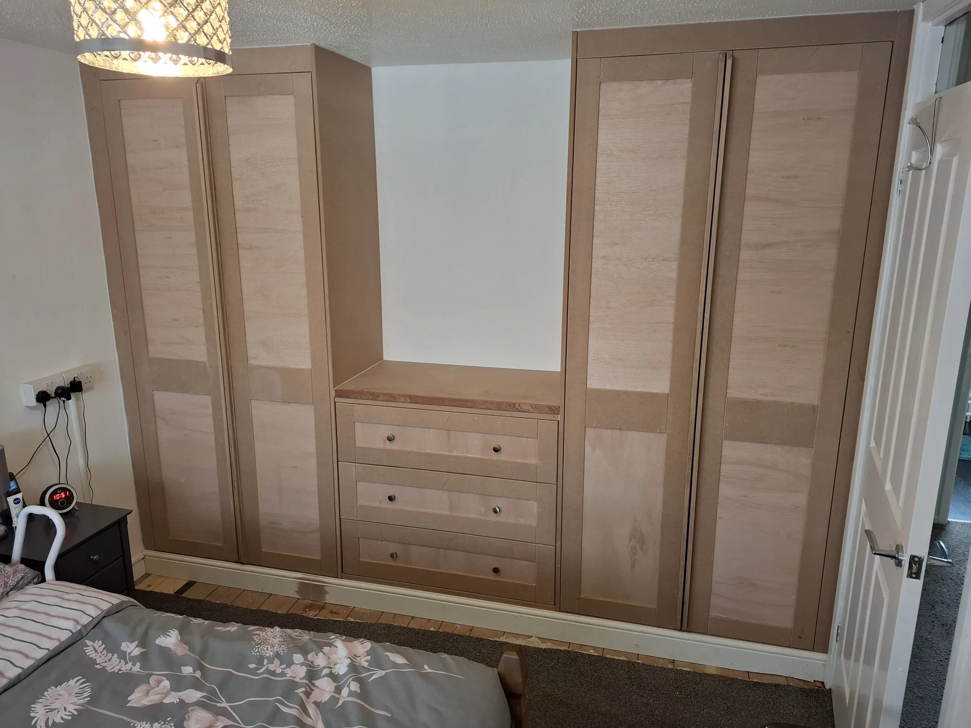 Pair of fitted wardrobes with drawers between